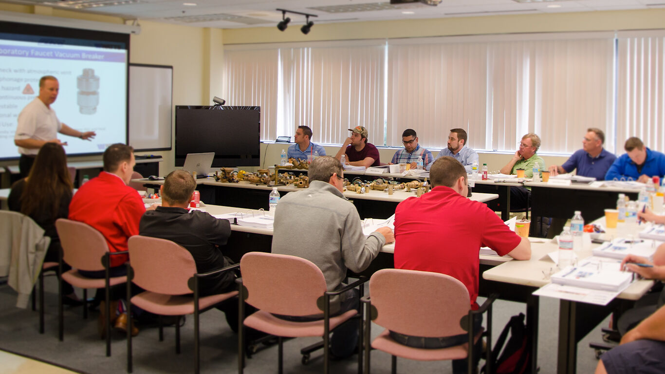 Group of people learning from a presentation